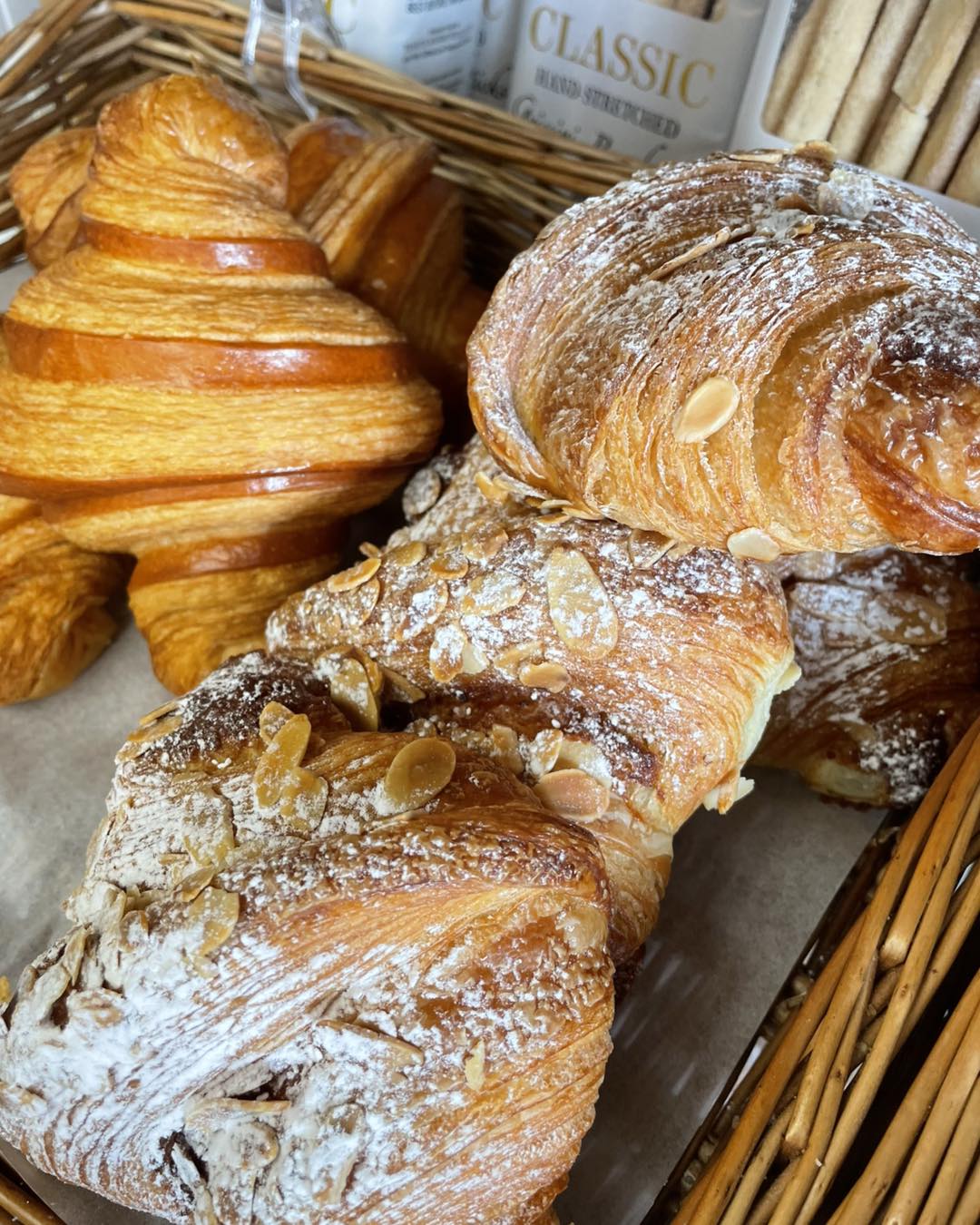 Almond croissants stacked in a basket